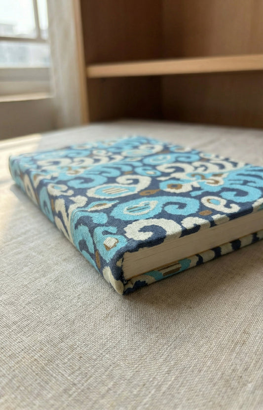 Book with a blue and white pattern on a textured surface